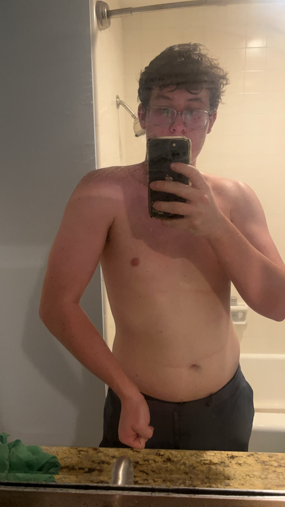 Theo taking a mirror photo before a fitness transformation