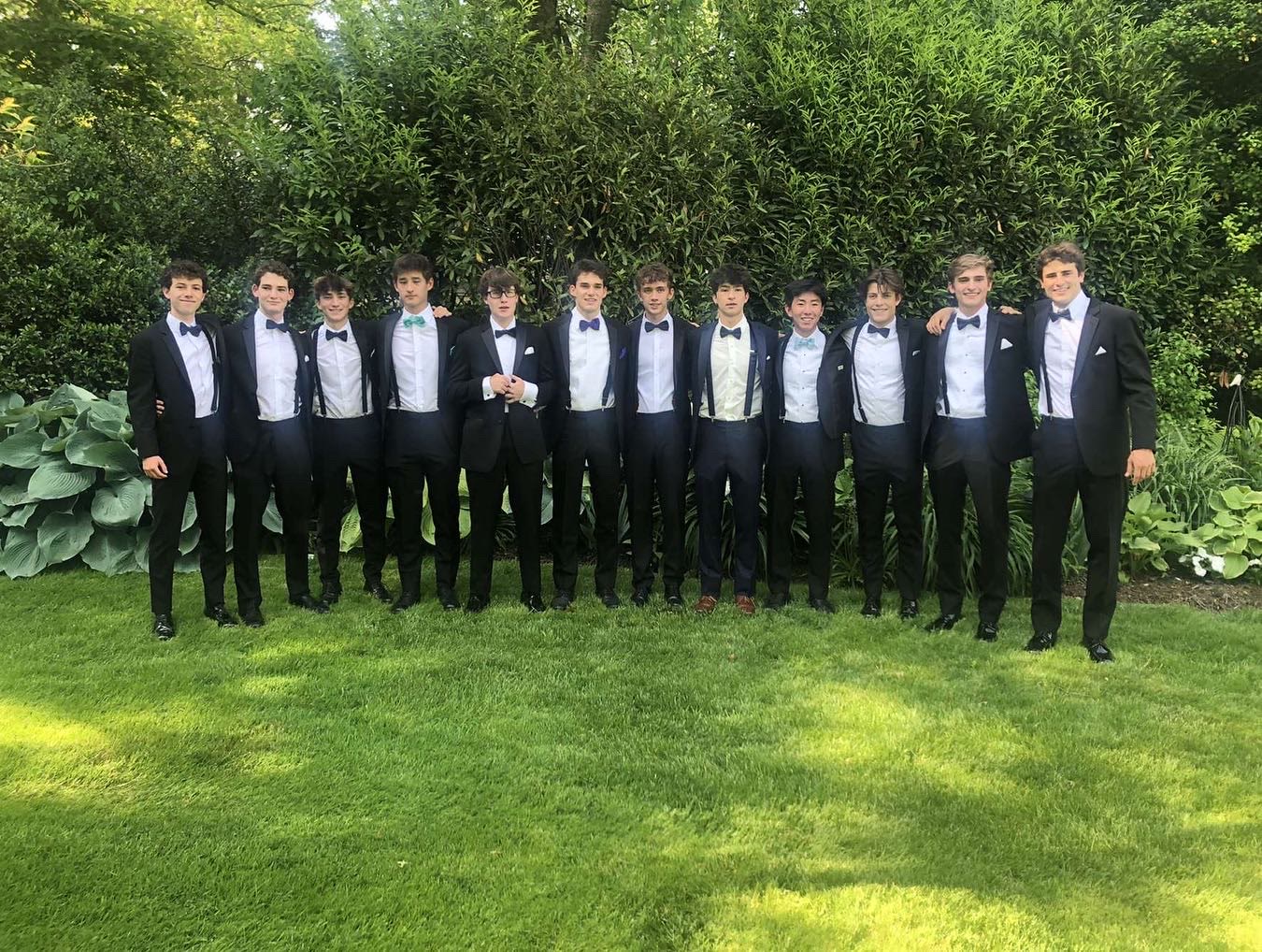 Theo with friends in formalwear outside